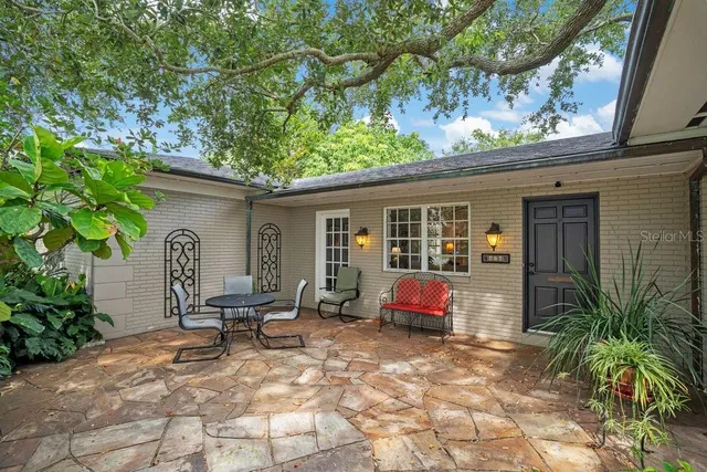 a backyard of a house with yard and outdoor seating