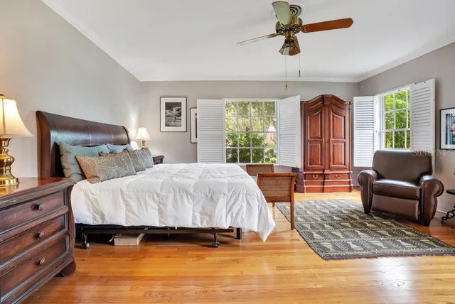 a bedroom with a bed a couch and a window