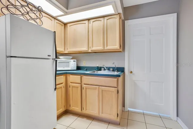 a white refrigerator freezer sitting in a kitchen