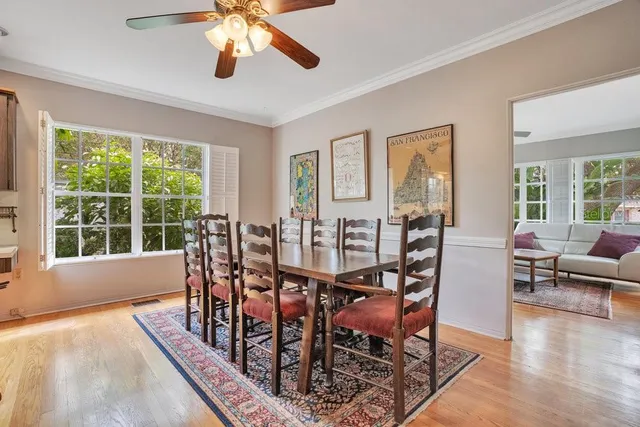 a view of a dining room with furniture window and wooden floor