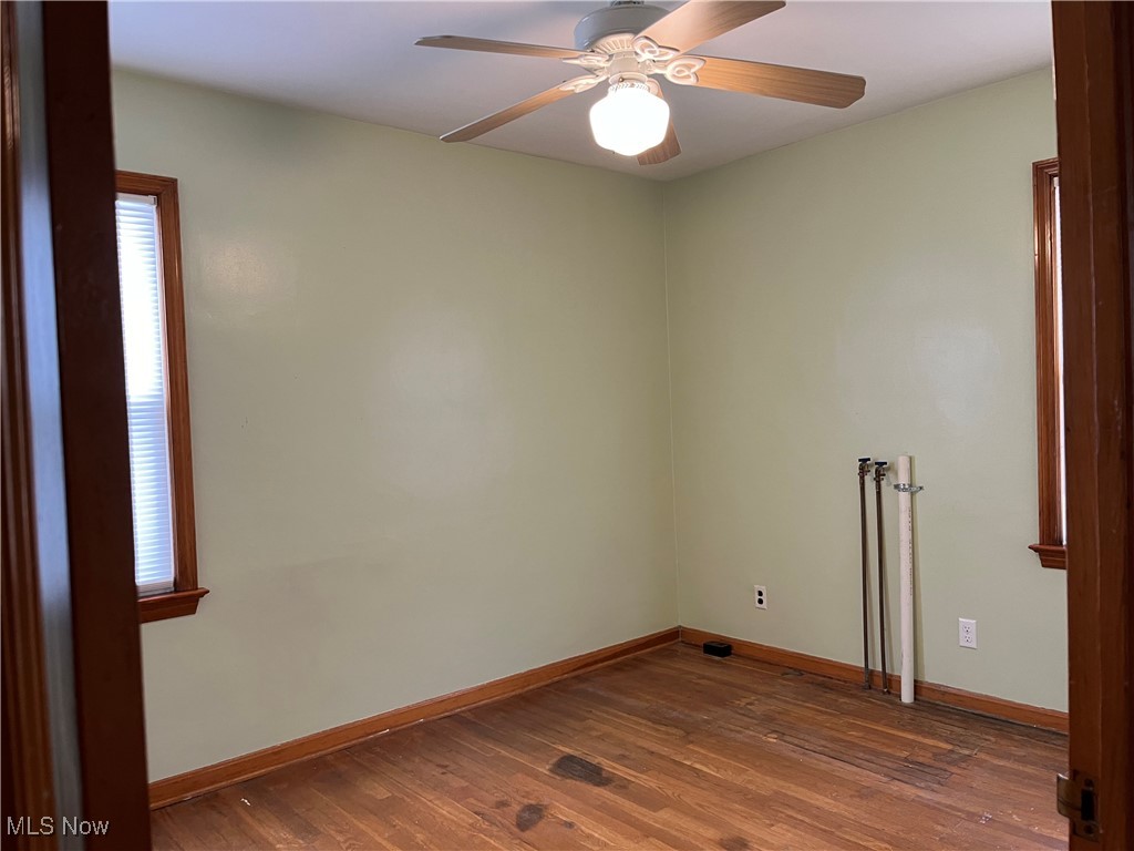 15405 Corkhill Road Maple Heights, OH 44137 - Photo 22 of 50 Back Bedroom with hardwood floor, ceiling fan light and washer and dryer hook up.