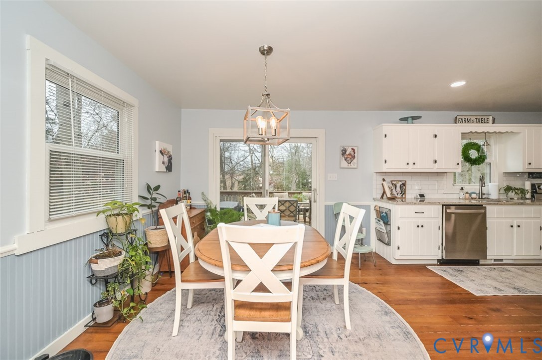 10217 Atlee Station Road Mechanicsville, VA 23116 - Photo 11 of 45 a view of a dining room with furniture large windows and wooden floor