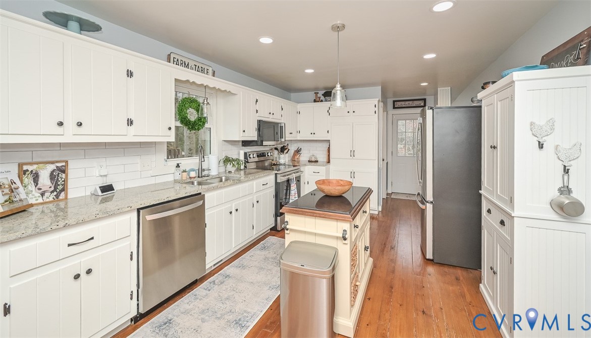 10217 Atlee Station Road Mechanicsville, VA 23116 - Photo 13 of 45 a kitchen with white cabinets and refrigerator