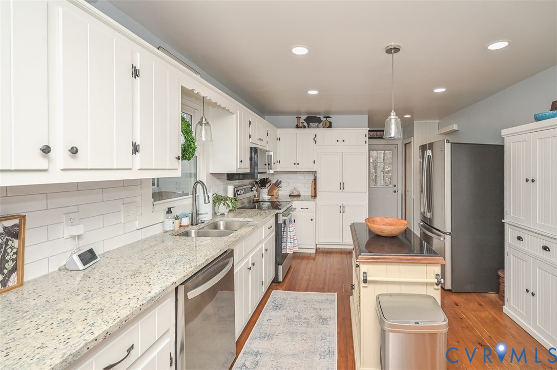 10217 Atlee Station Road Mechanicsville, VA 23116 - Photo 14 of 45 a kitchen with a sink stove and refrigerator