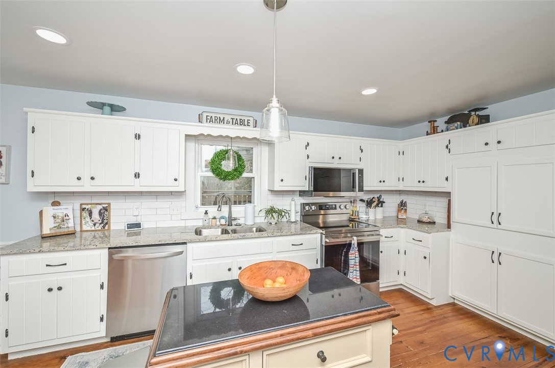 10217 Atlee Station Road Mechanicsville, VA 23116 - Photo 15 of 45 a kitchen with white cabinets and white appliances