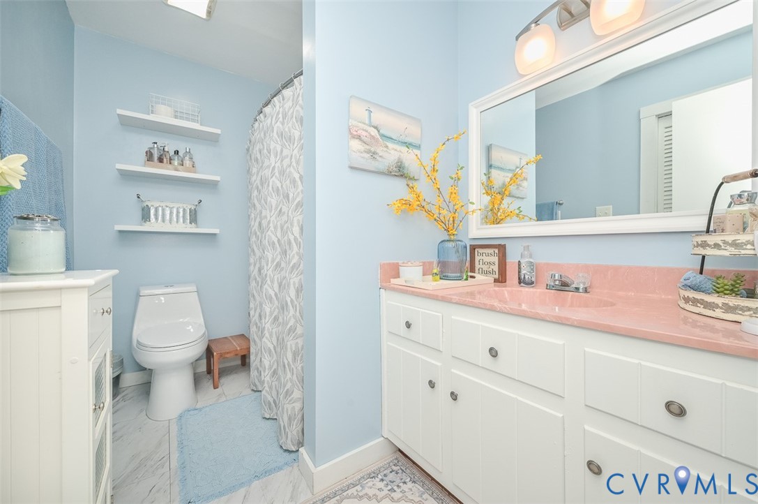 10217 Atlee Station Road Mechanicsville, VA 23116 - Photo 21 of 45 a bathroom with a sink a toilet and a mirror