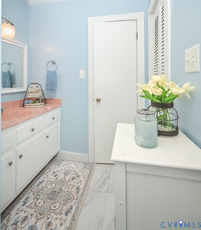 10217 Atlee Station Road Mechanicsville, VA 23116 - Photo 22 of 45 a view of bathroom with a sink a vanity and a potted plant