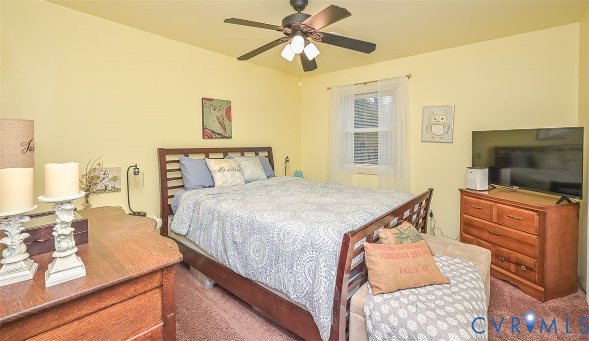 10217 Atlee Station Road Mechanicsville, VA 23116 - Photo 23 of 45 a bedroom with a bed and a flat screen tv
