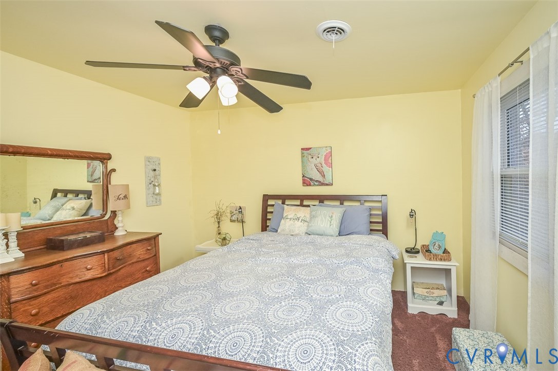 10217 Atlee Station Road Mechanicsville, VA 23116 - Photo 24 of 45 a bedroom with a bed and a dresser in it