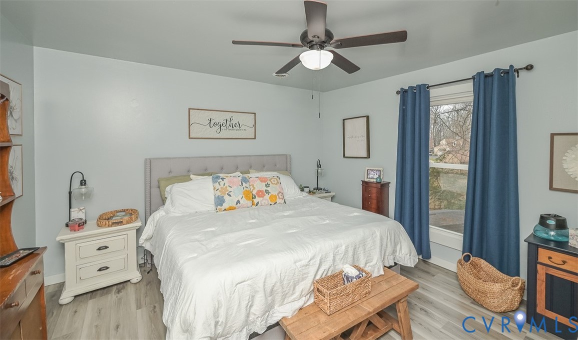 10217 Atlee Station Road Mechanicsville, VA 23116 - Photo 28 of 45 a bedroom with a bed and wooden floor