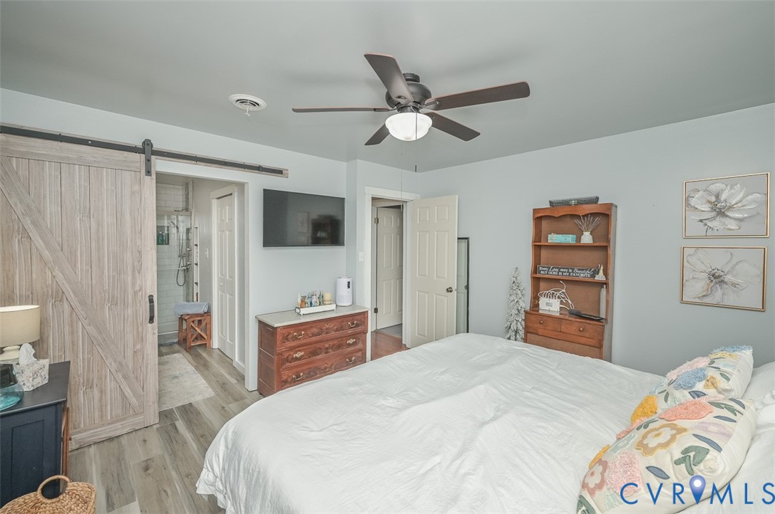 10217 Atlee Station Road Mechanicsville, VA 23116 - Photo 30 of 45 a bedroom with a bed and a chandelier