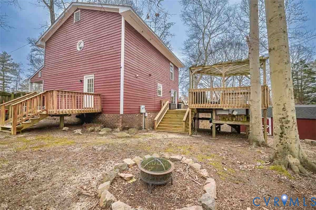 10217 Atlee Station Road Mechanicsville, VA 23116 - Photo 45 of 45 a backyard of a house with barbeque oven table and chairs