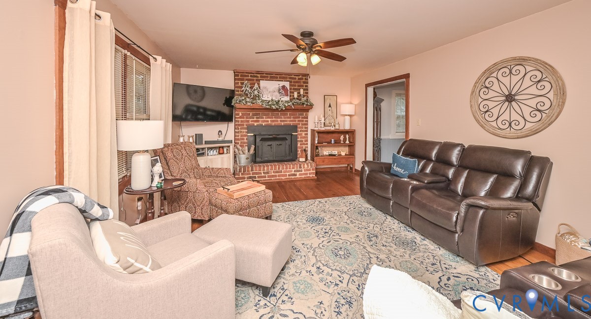 10217 Atlee Station Road Mechanicsville, VA 23116 - Photo 6 of 45 a living room with furniture a fireplace and a chandelier