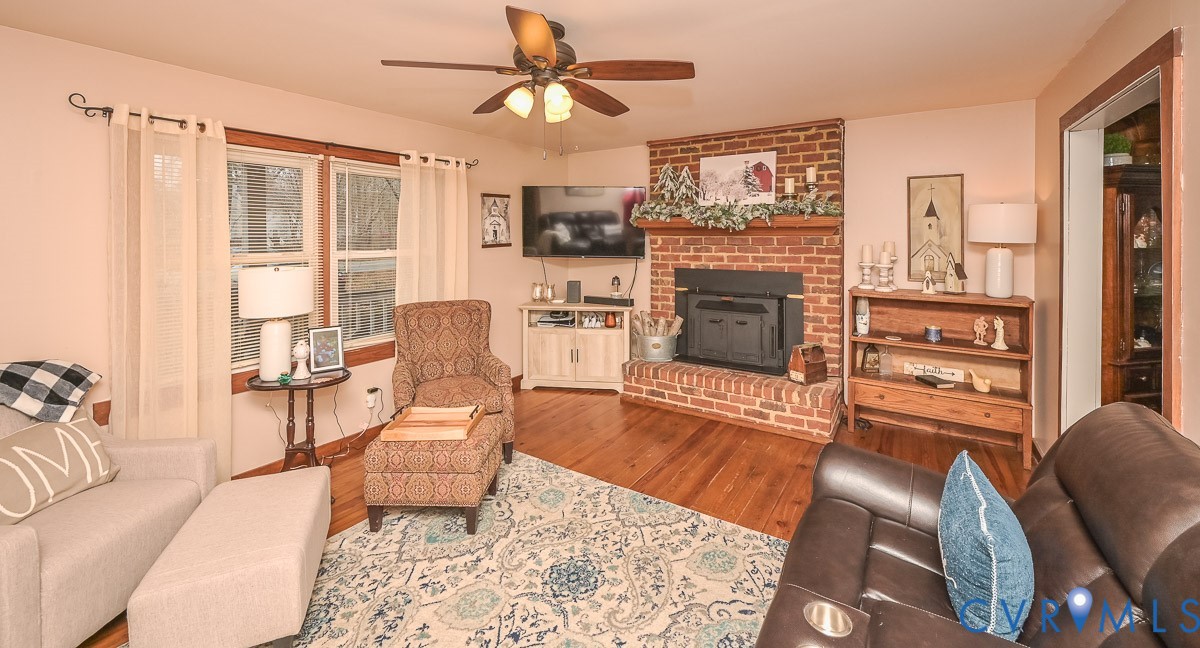 10217 Atlee Station Road Mechanicsville, VA 23116 - Photo 8 of 45 a living room with furniture and a fireplace