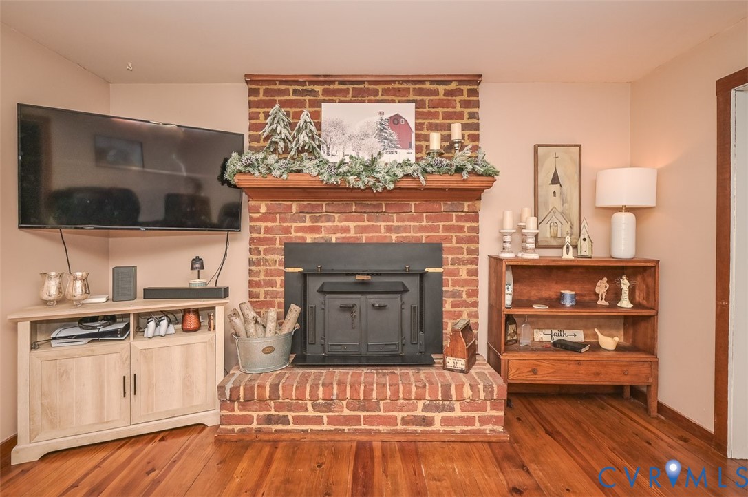 10217 Atlee Station Road Mechanicsville, VA 23116 - Photo 9 of 45 a living room with a fireplace and a flat screen tv