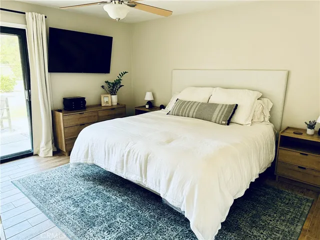 a bedroom with a bed a mirror and lamp