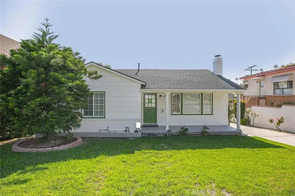 a front view of house with yard and outdoor seating