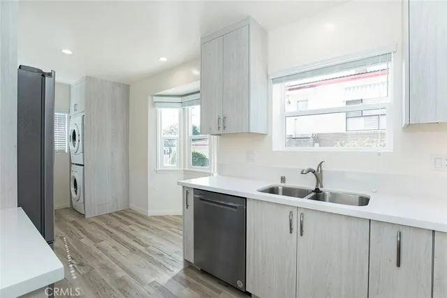 a kitchen with stainless steel appliances a sink a stove a microwave and cabinets