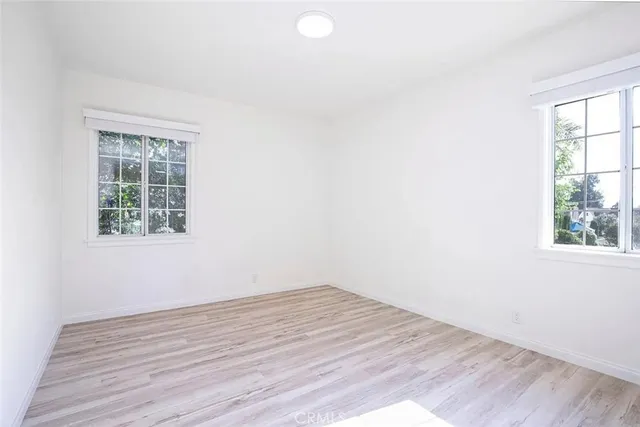 a view of wooden floor and windows in a room