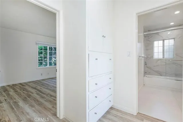a view of an empty room with wooden floor