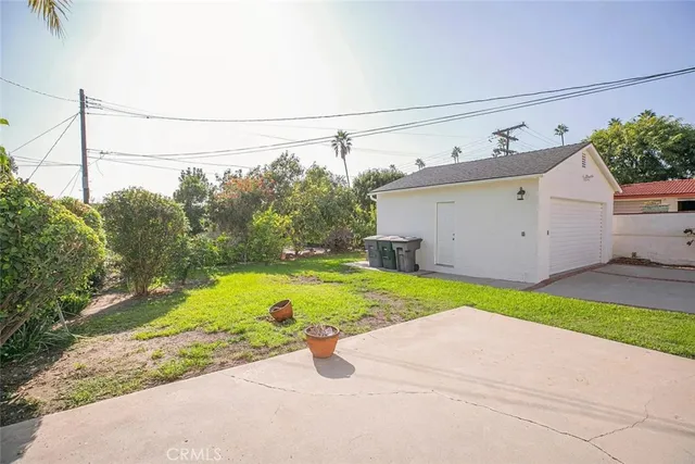 a backyard of a house with lots of green space and garden