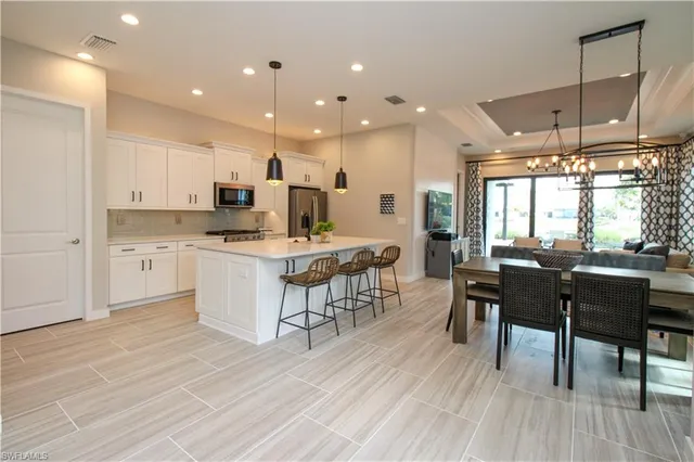 a large kitchen with a table and chairs