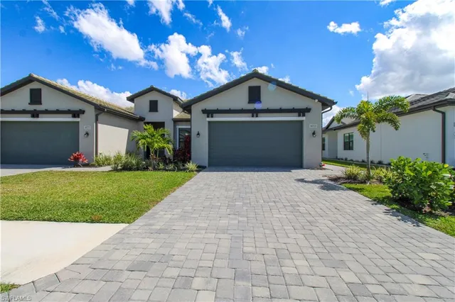 a front view of a house with a yard and a garage