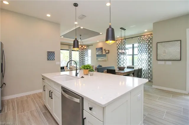 a kitchen with a sink a counter space and wooden floor