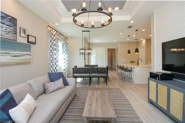 a living room with furniture a rug and a flat screen tv