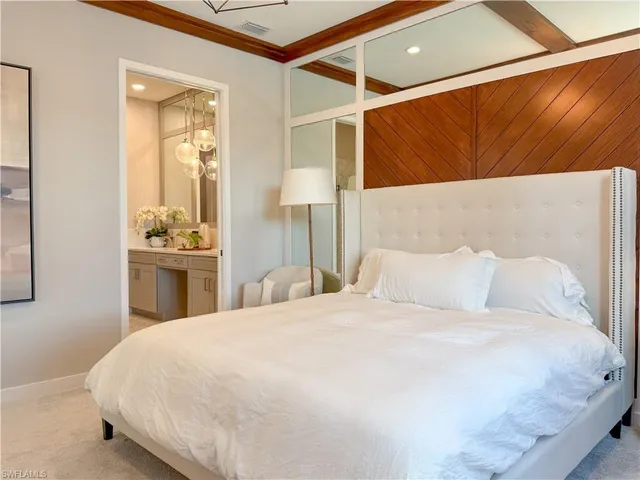 a large white bed in a white room