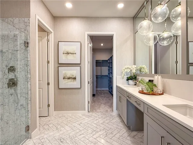 a bathroom with a sink a mirror and a shower