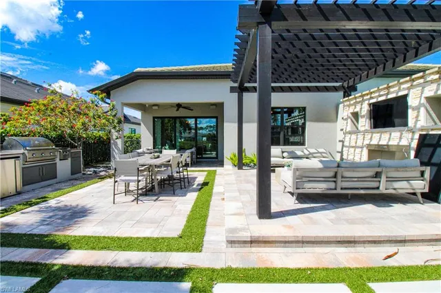 a view of a patio with dining table and chairs with garden view