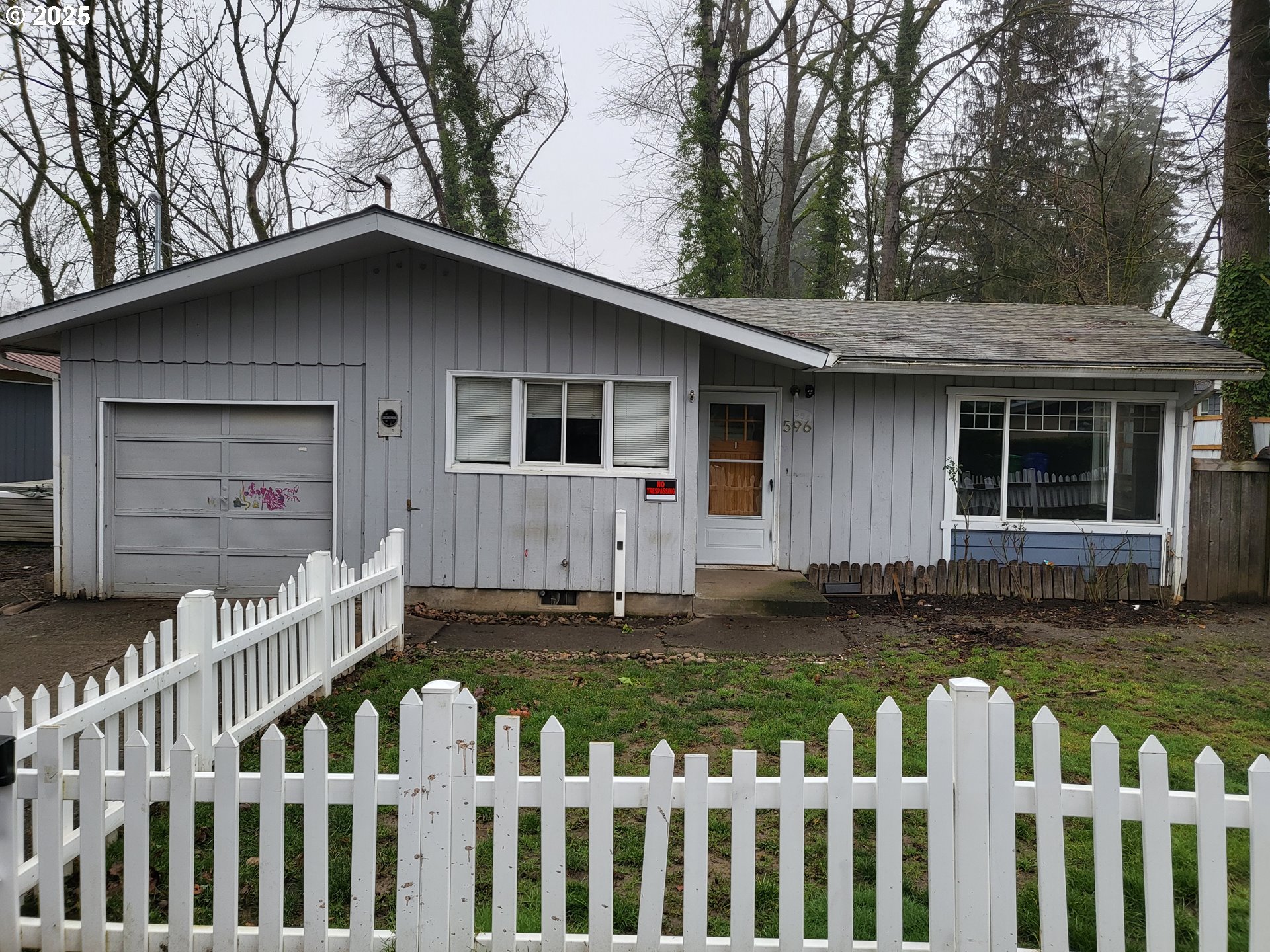 596 Northeast Linden Avenue Gresham, OR 97030 - Photo 1 of 18 a house with white fence and a yard