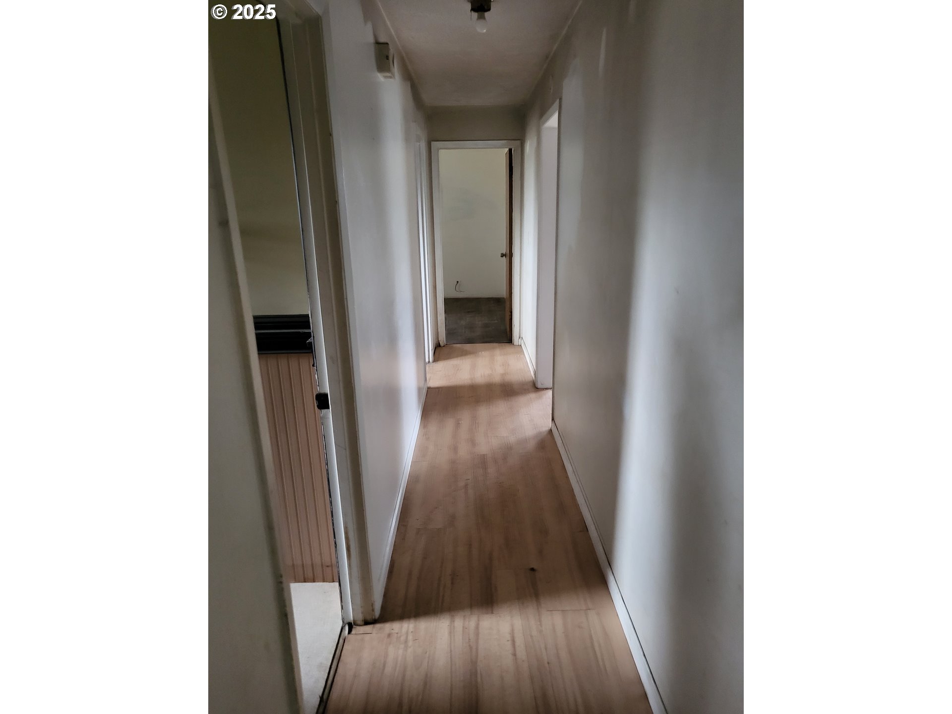 596 Northeast Linden Avenue Gresham, OR 97030 - Photo 13 of 18 a view of a hallway with wooden floor
