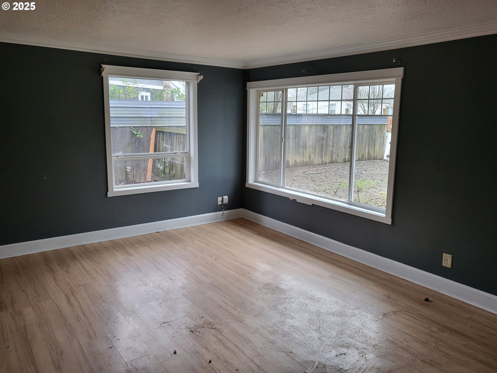 596 Northeast Linden Avenue Gresham, OR 97030 - Photo 5 of 18 an empty room with wooden floor and windows