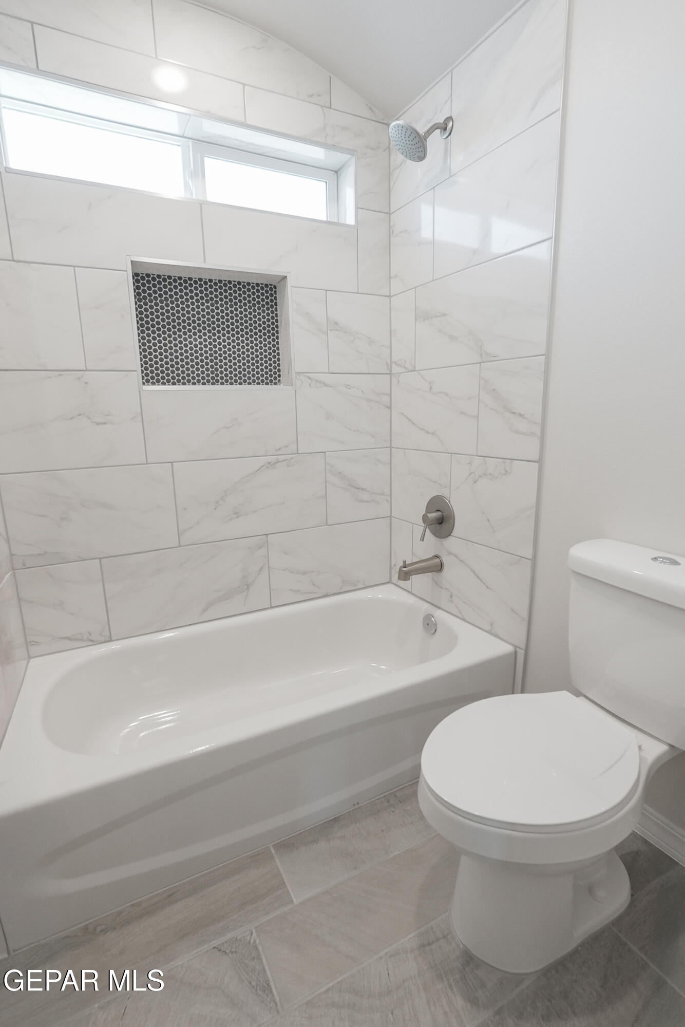 12436 Fill Ball Street El Paso, TX 79928 - Photo 16 of 31 a white toilet and tub sitting next to a bathroom sink