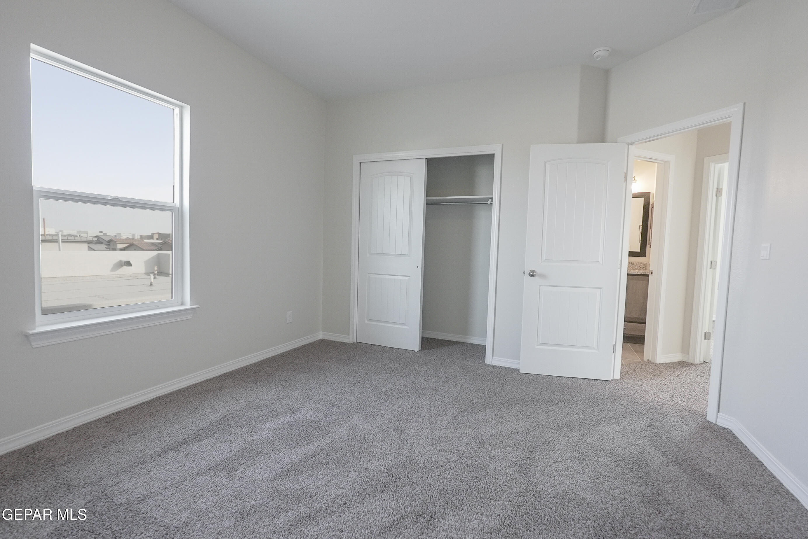 12436 Fill Ball Street El Paso, TX 79928 - Photo 18 of 31 a view of an empty room with windows and closet