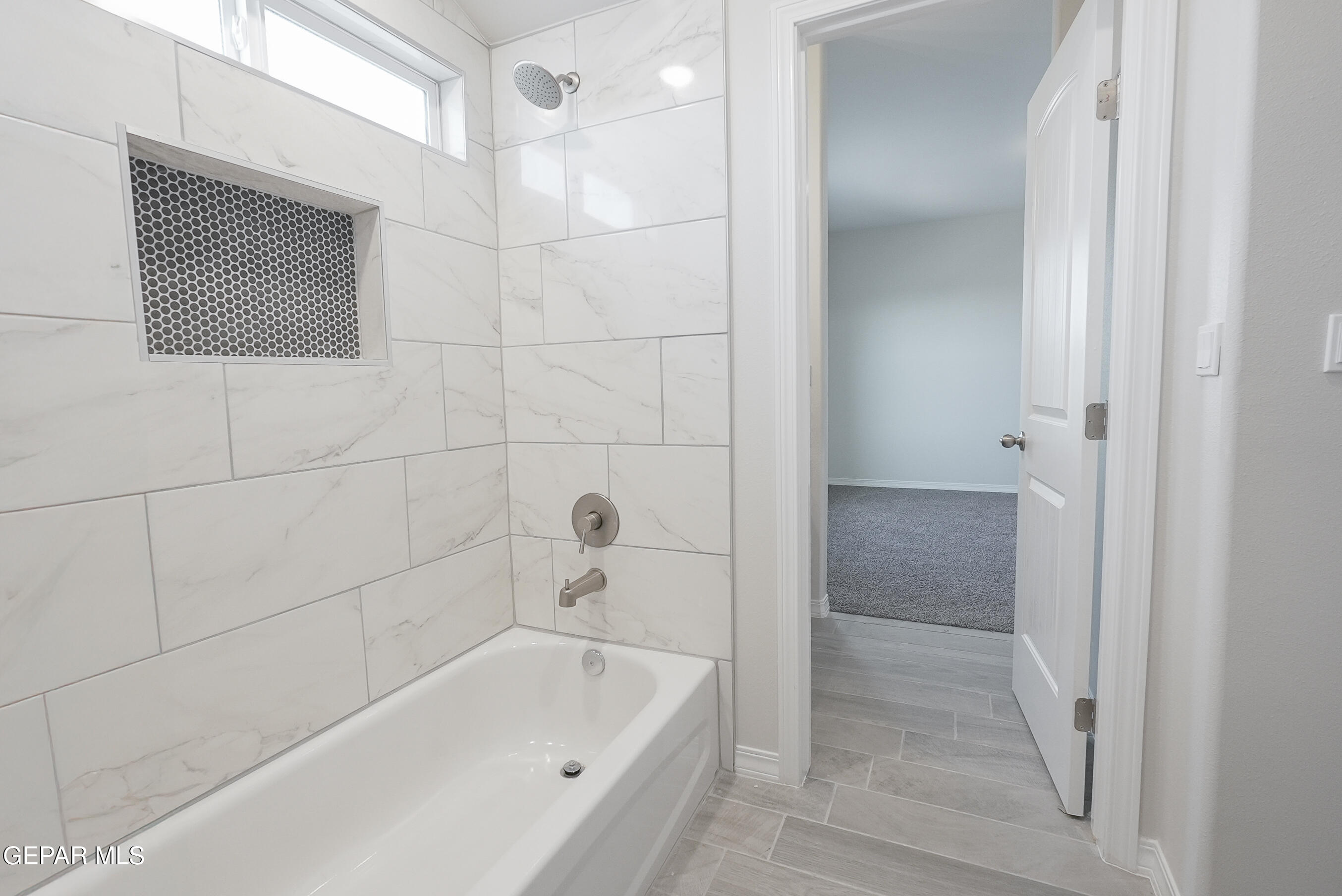 12436 Fill Ball Street El Paso, TX 79928 - Photo 21 of 31 a bathroom with a bathtub and shower