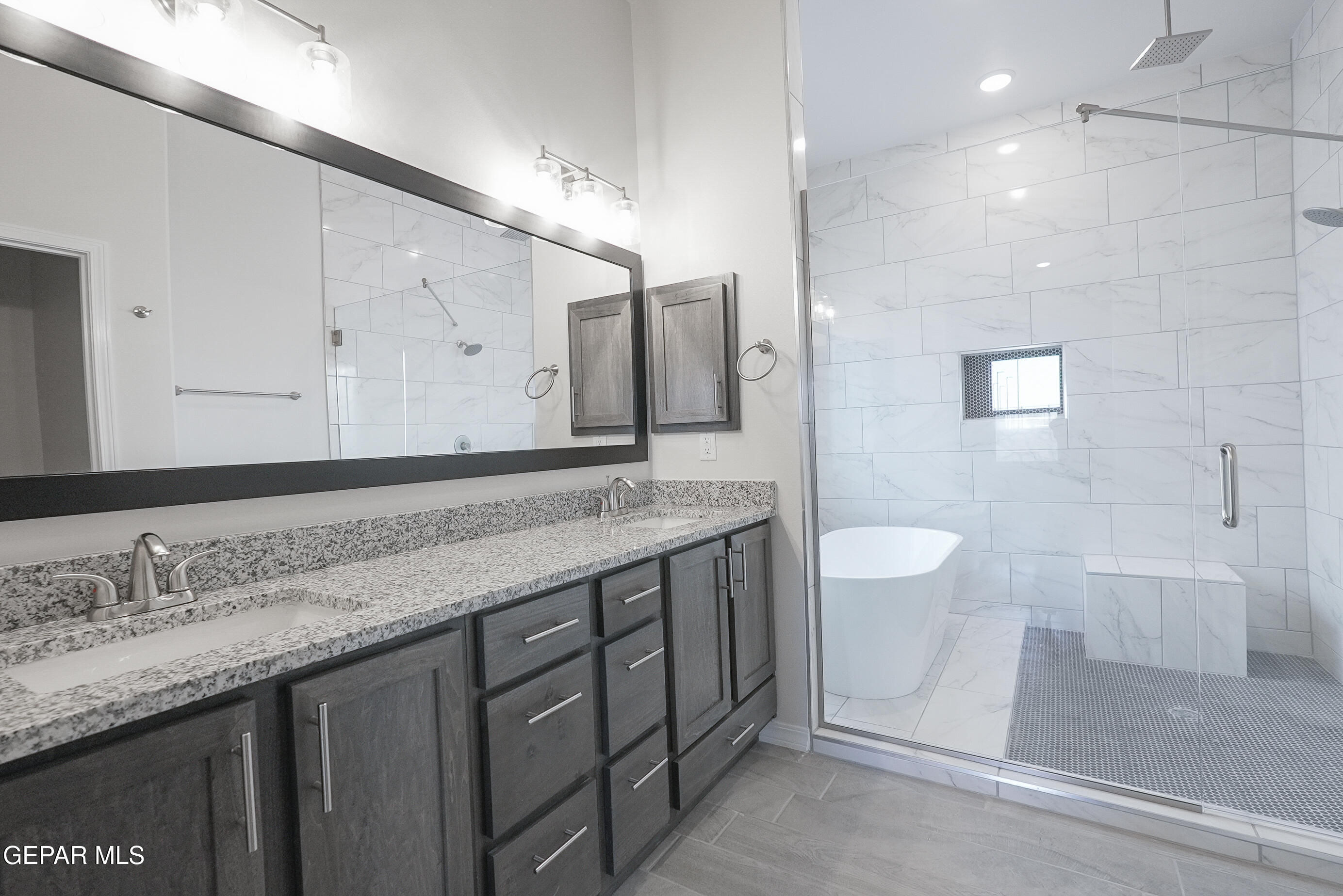 12436 Fill Ball Street El Paso, TX 79928 - Photo 28 of 31 a bathroom with a granite countertop sink a toilet and a shower
