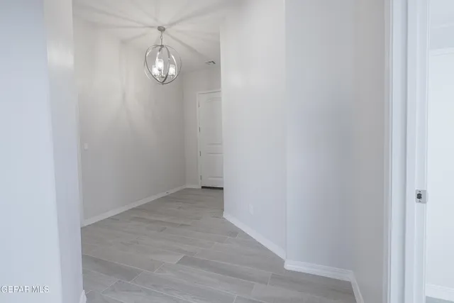a view of a room with wooden floor and fan