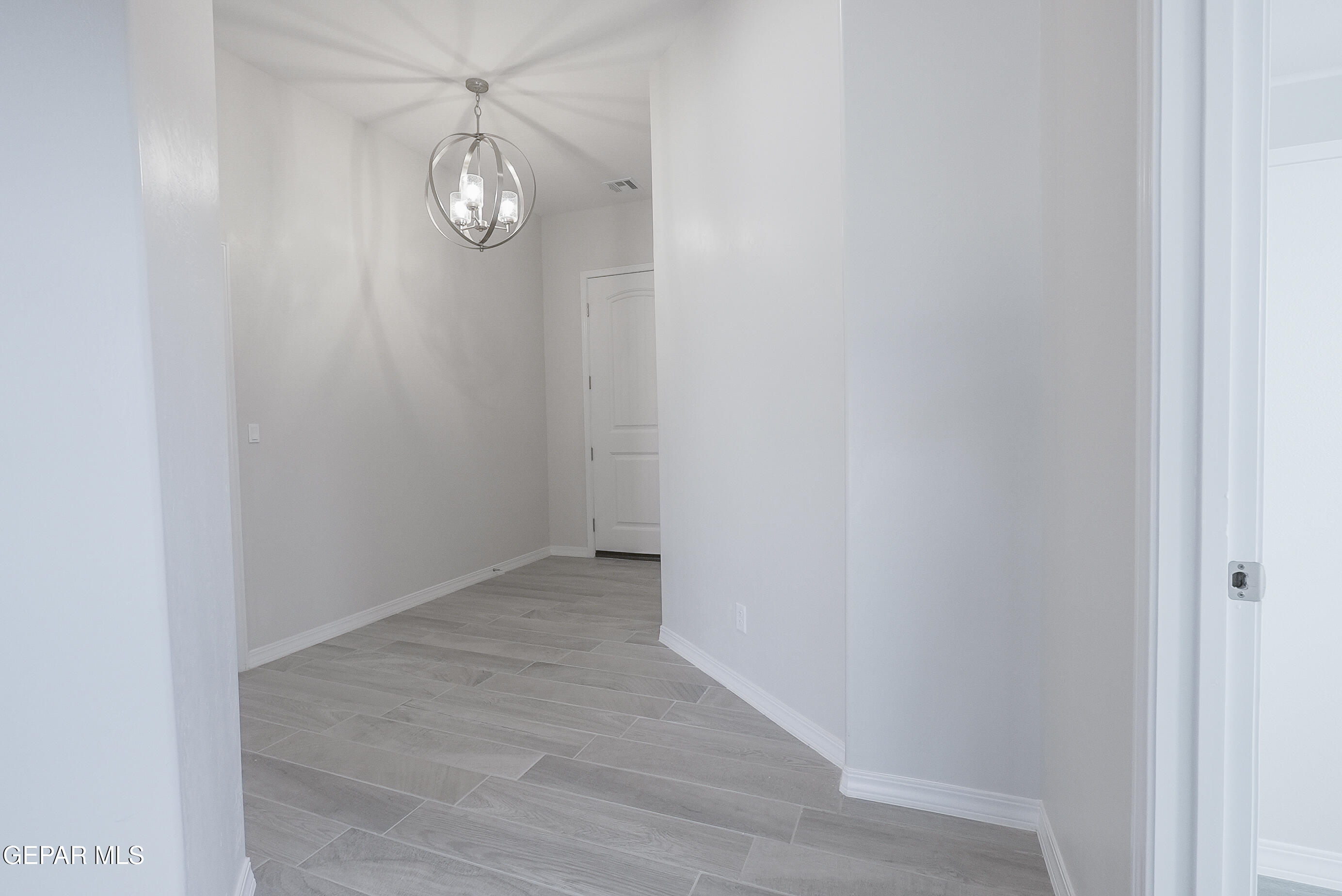 12436 Fill Ball Street El Paso, TX 79928 - Photo 4 of 31 a view of a room with wooden floor and fan
