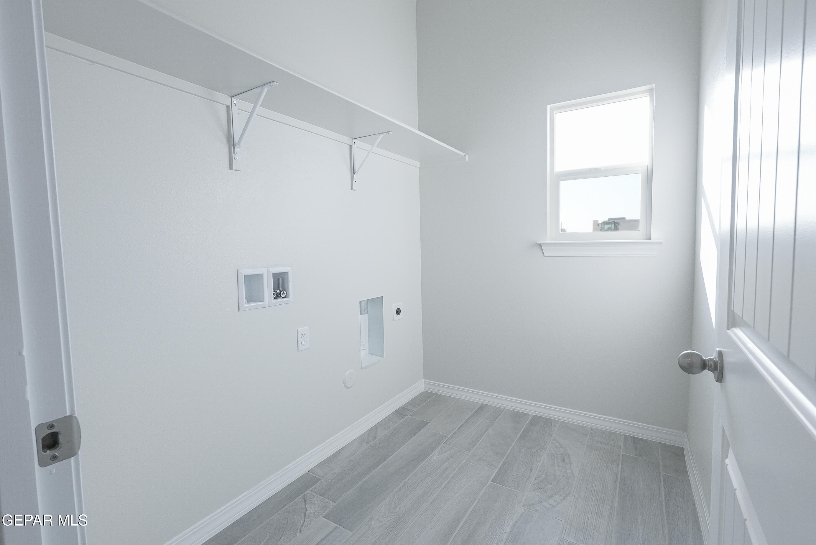 12436 Fill Ball Street El Paso, TX 79928 - Photo 5 of 31 a view of a small space with wooden floor and a window