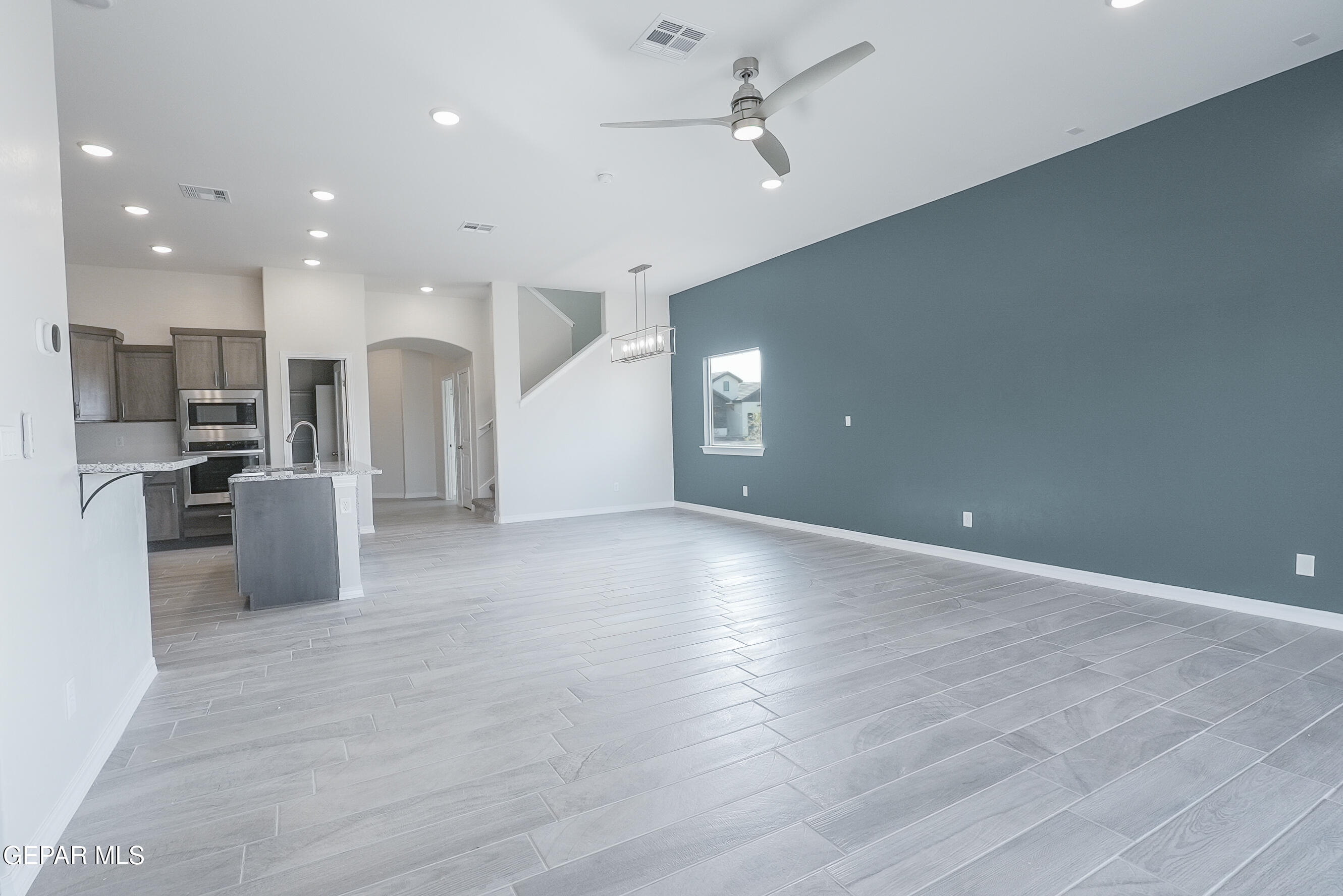 12436 Fill Ball Street El Paso, TX 79928 - Photo 6 of 31 a view of a kitchen with a refrigerator and a sink