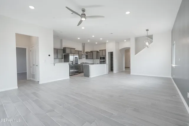 a view of a kitchen with a sink and a refrigerator