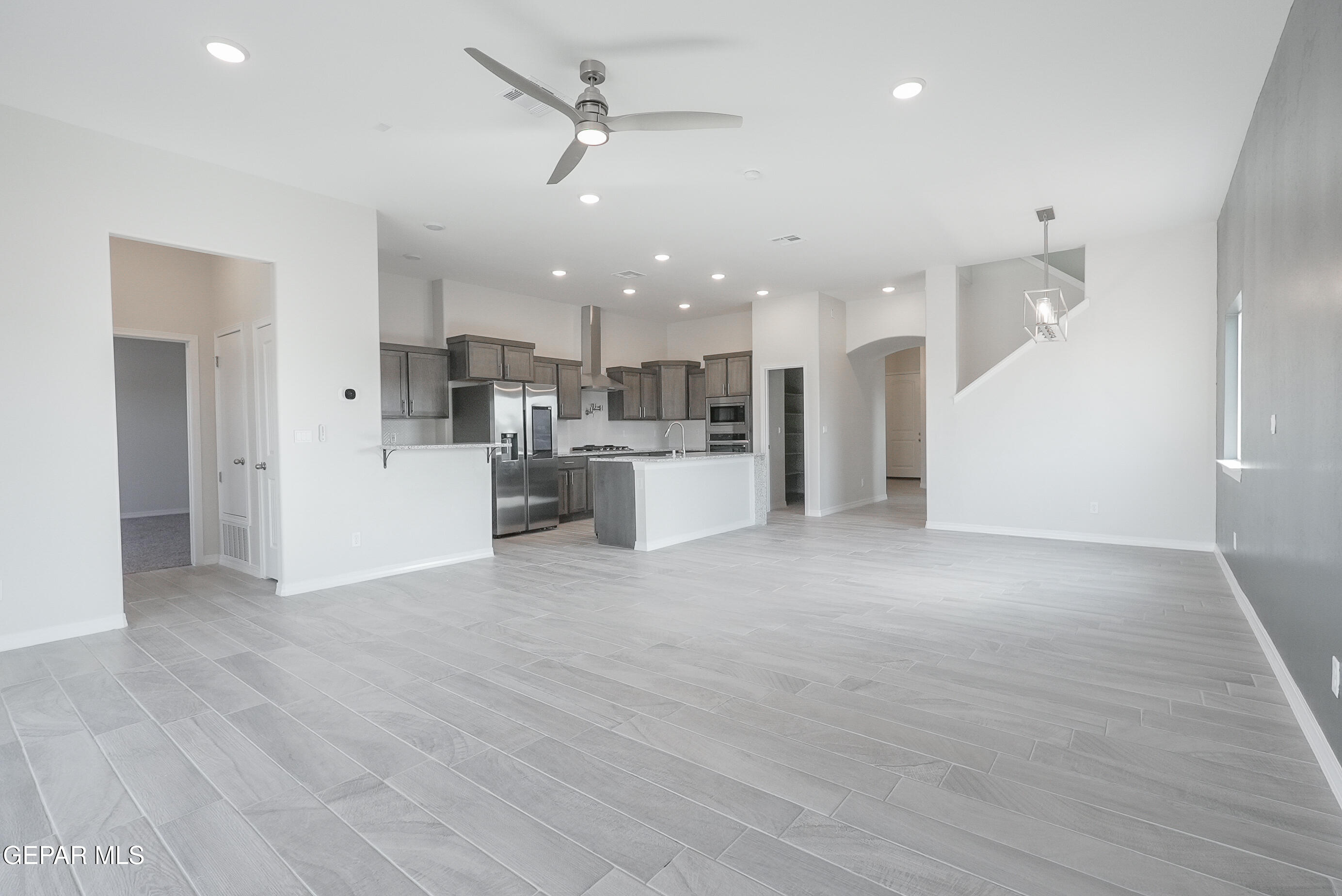 12436 Fill Ball Street El Paso, TX 79928 - Photo 7 of 31 a view of a kitchen with a sink and a refrigerator
