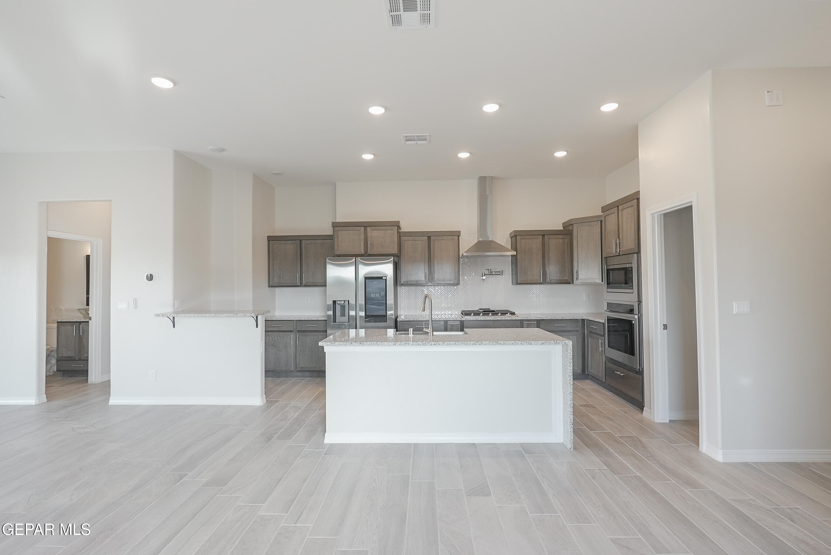 12436 Fill Ball Street El Paso, TX 79928 - Photo 8 of 31 a kitchen with stainless steel appliances a refrigerator and a stove top oven