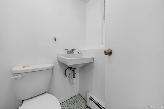 a bathroom with a sink toilet and a mirror