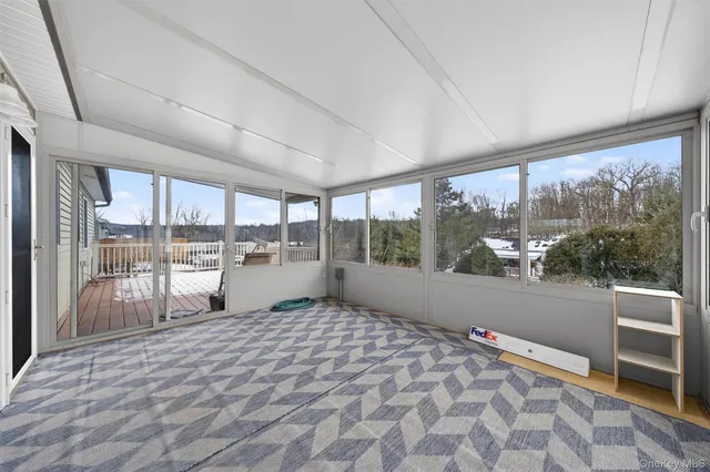 a room with a bed and large window