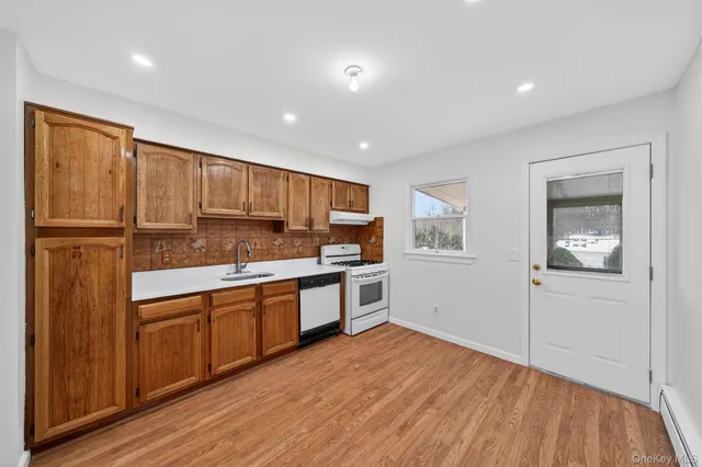 a kitchen with stainless steel appliances granite countertop a refrigerator and a stove top oven