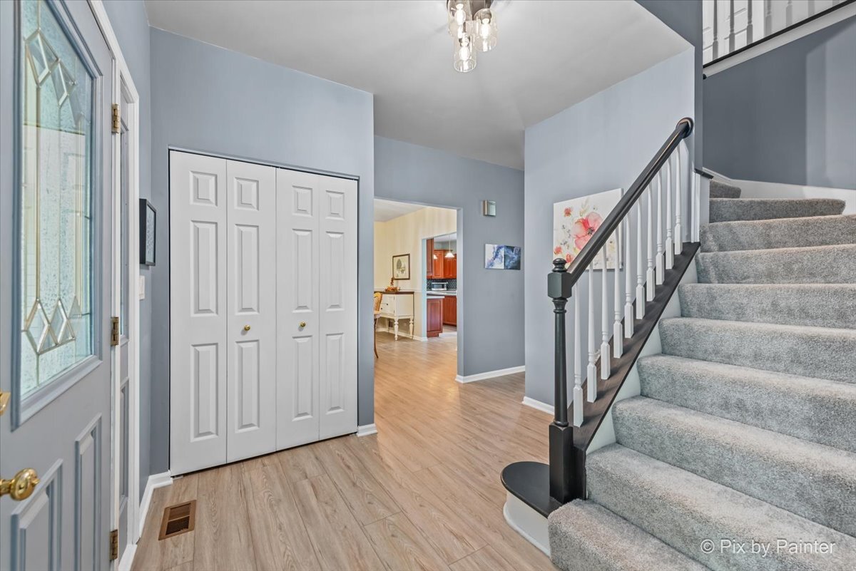 1820 Crofton Drive Algonquin, IL 60102 - Photo 11 of 60 a view of entryway with wooden floor and stairs